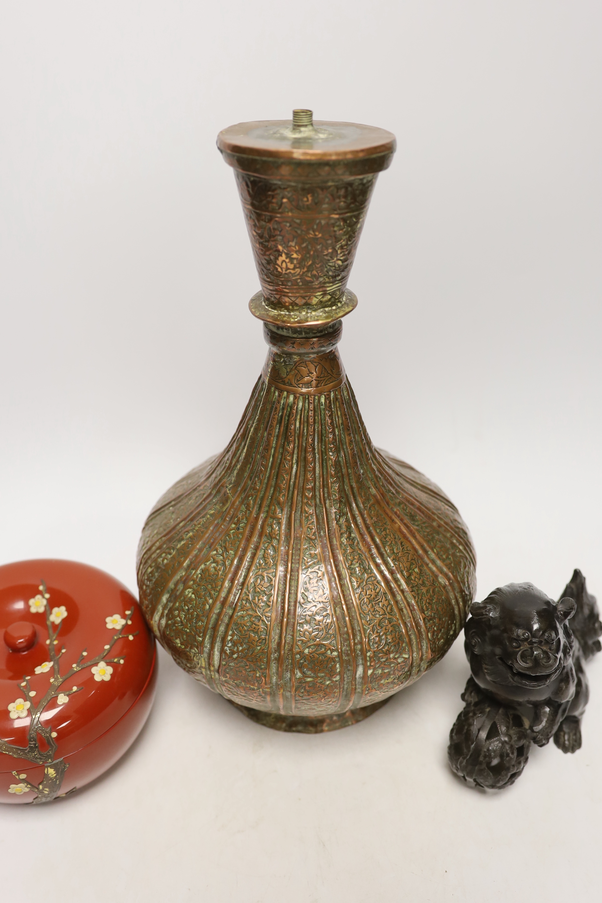 A Persian copper converted lamp, Chinese dog of Fo and a box and cover, tallest 34cm